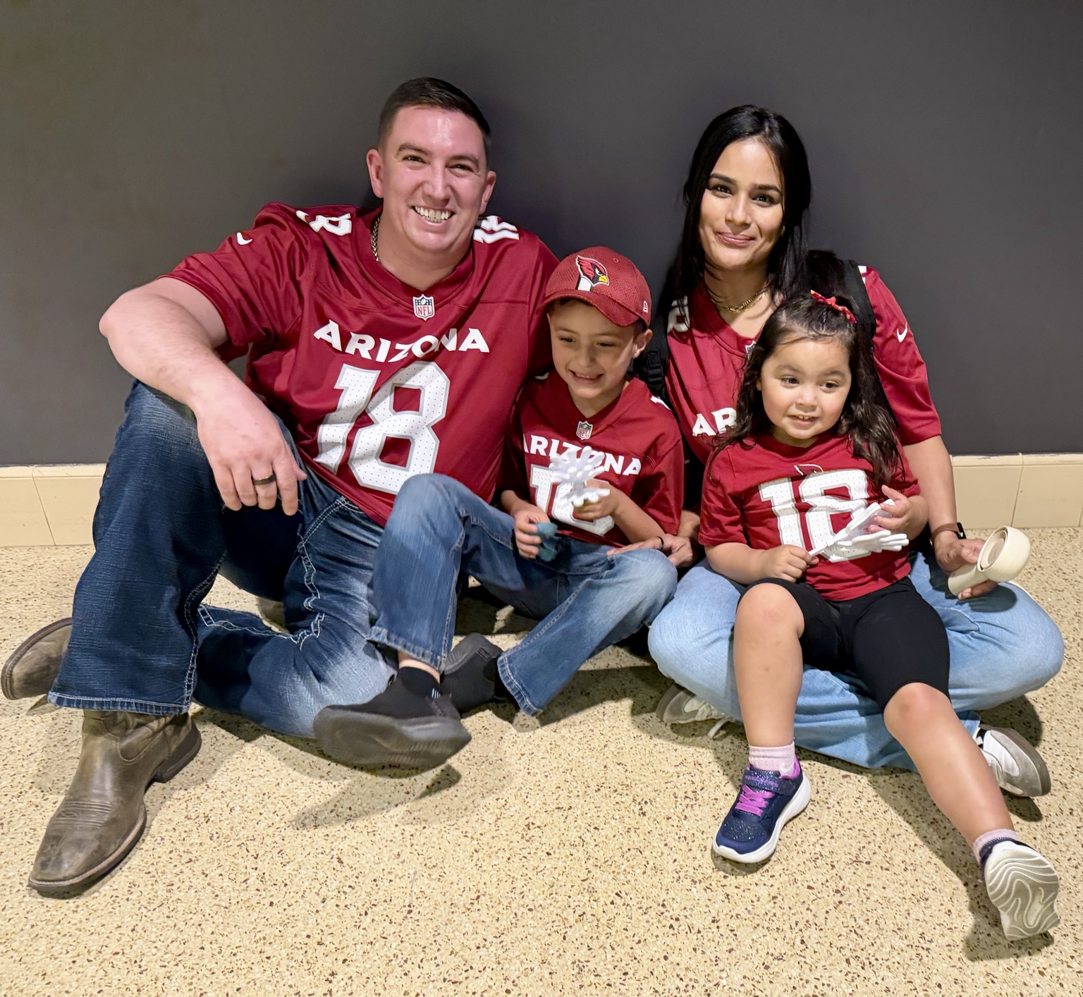Carmen Angle with her family wearing Arizona Cardinals jerseys